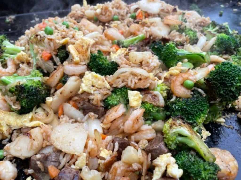 Fried rice done cooking and ready to come off the griddle. 