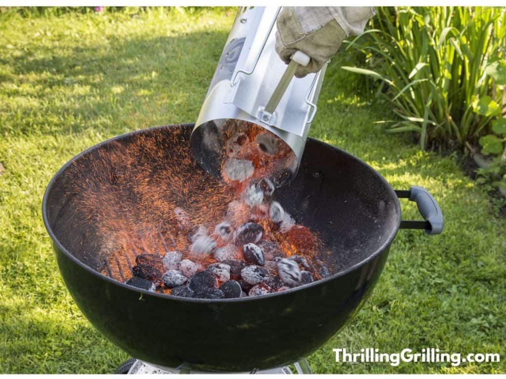 One of the best charcoal chimney starters pouring hot charcoal into a Weber kettle grill