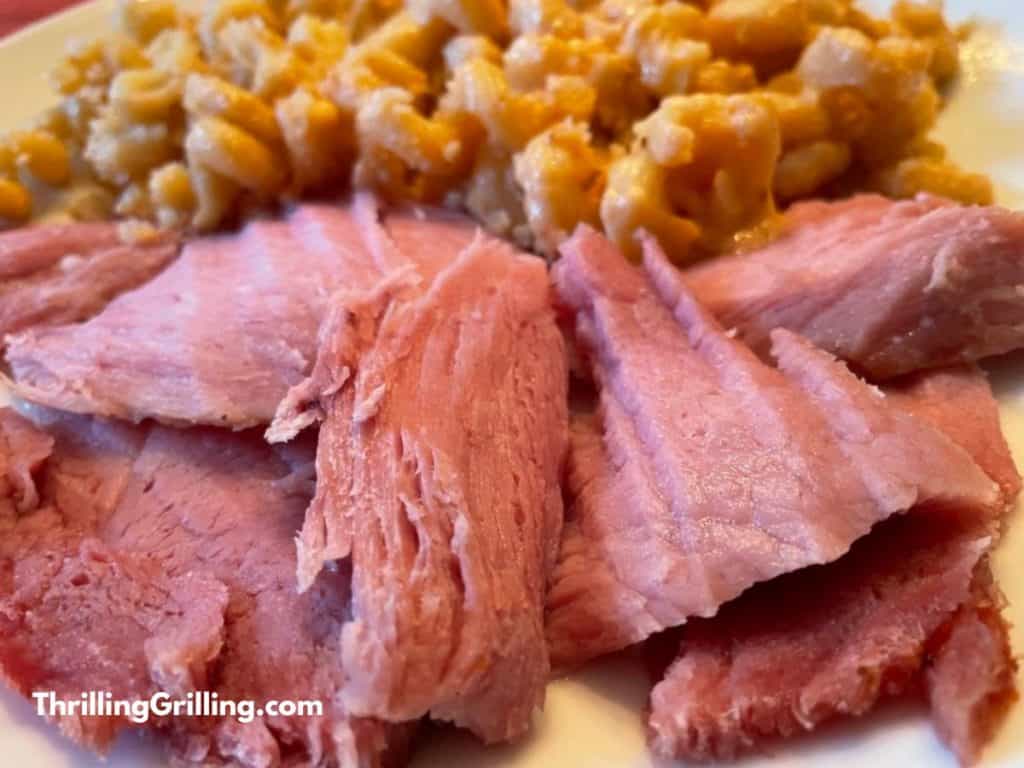Sliced ham served with homemade mac and cheese