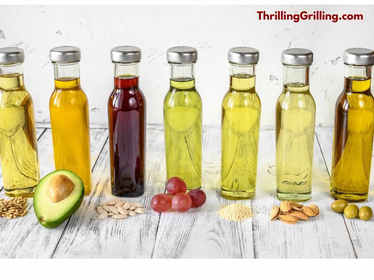 A number of bottles containing the best oil to use on a Blackstone griddle including olive, grapeseed, canola, and avocado.