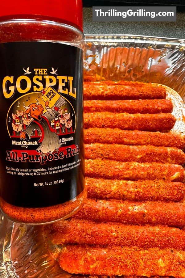 A tray of hot dogs rubbed with BBQ rub and a canister of Meat Church rub.